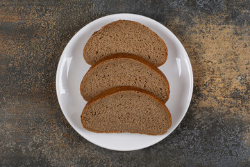 Rye black bread slices on white plate