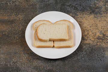 Sliced brown bread on white plate