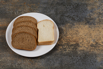 Black and white bread slices on white plate