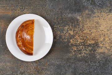 Half cut fresh pastry on white plate