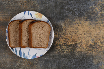 Black toast bread on colorful plate
