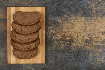 Sliced rye bread on wooden board