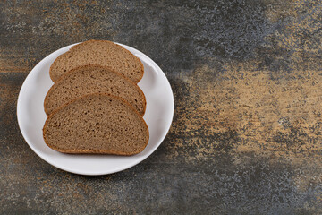 Rye black bread slices on white plate