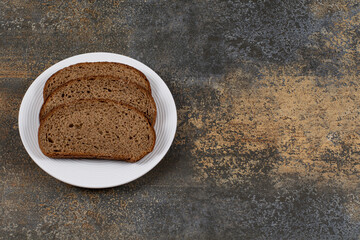 Rye black bread slices on white plate