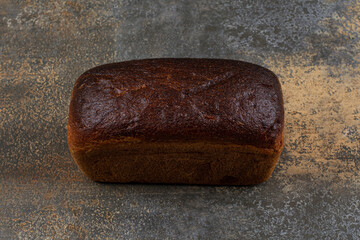 Delicious loaf bread on marble background