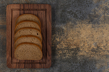 Sliced tasty black bread on wooden plate
