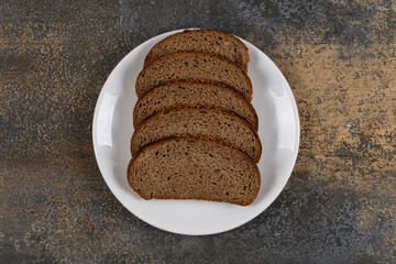 Fototapeta na wymiar Several slices of rye bread on white plate