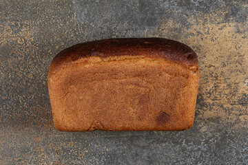Delicious loaf bread on marble background
