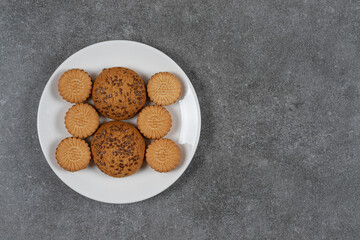 Cookie and biscuit on the plate, on the marble background