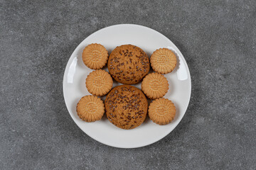 Cookie and biscuit on the plate, on the marble background