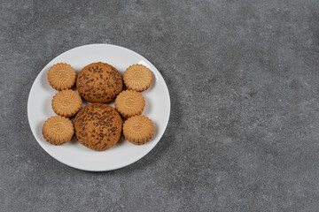 Biscuits and cookie on the plate, on the marble background