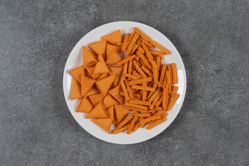 Various chips on the plate , on the marble background