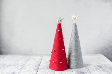 Christmas greeting card with yarn wrapped XMAS cone trees. Two handmade Christmas trees with copy...