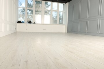 Empty room with new white laminated flooring