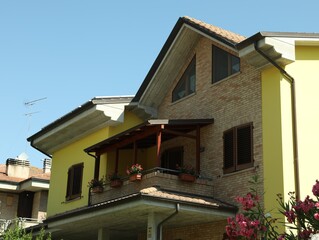 Exterior of residential building with balcony on sunny day