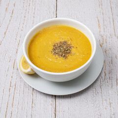 pumpkin soup in a white bowl