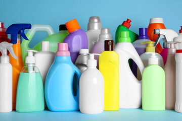 Many different cleaning supplies on light blue background