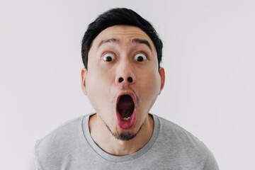 Funny shocked surprised closeup asian face man isolated on white background.