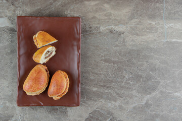 Homemade pastry with meat on brown plate