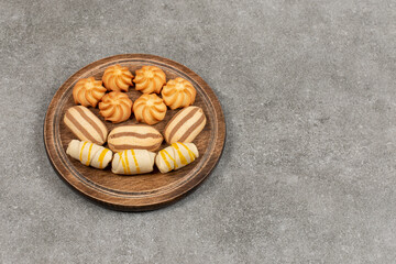 Variety of delicious sweets on wooden board