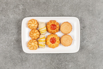 Assortment of delicious biscuits on white plate