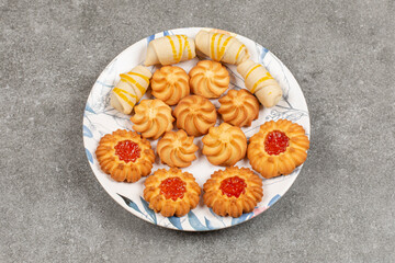 Assortment of delicious sweets on colorful plate
