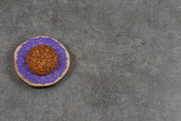 Sweet cookie with sesame seeds on wooden piece