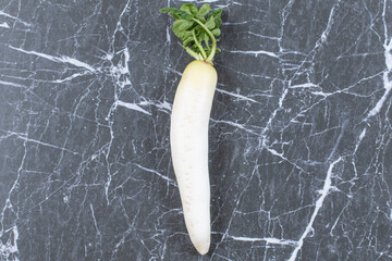 Fresh daikon radish on marble background