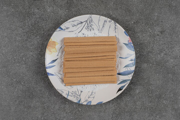 Bunch of stick biscuits on colorful plate
