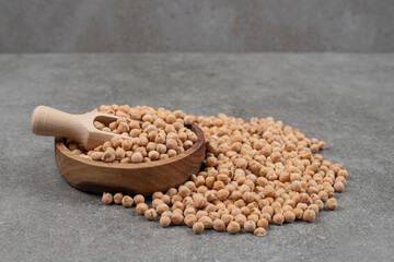 Pile of raw yellow peas in wooden bowl