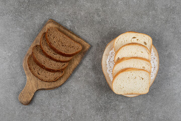 White and black bread slices on wooden boards