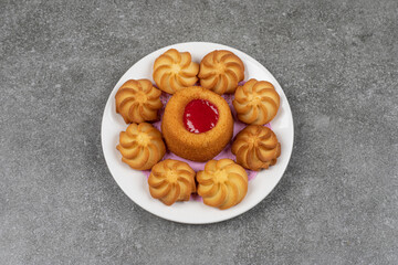 Delicious sweet biscuits on white plate