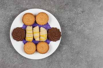 Plate of tasty desserts on marble background