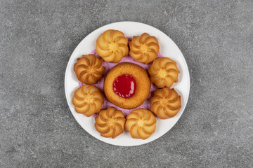 Delicious sweet biscuits on white plate