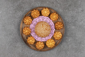 Tasty sweet biscuits on wooden board
