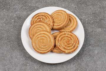 Crunchy biscuits with seeds on white plate