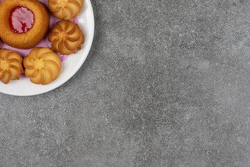 Delicious sweet biscuits on white plate