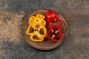 A tray of sweet pepper on the board , on the marble background