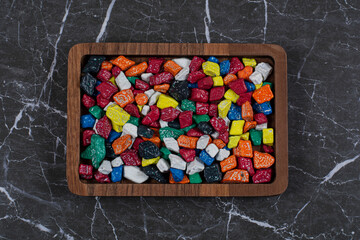A tray of colorful candies , on the marble background