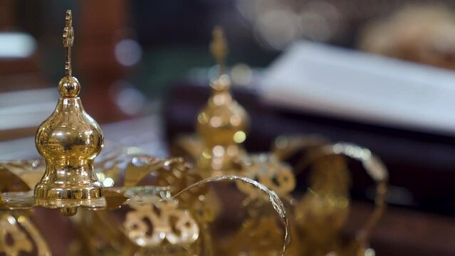 Closeup of golden crowns in an ortodox church during wedding matrimony