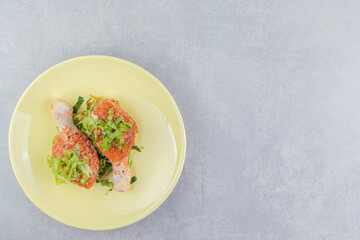 Raw marinated chicken legs in the plate, on the white background