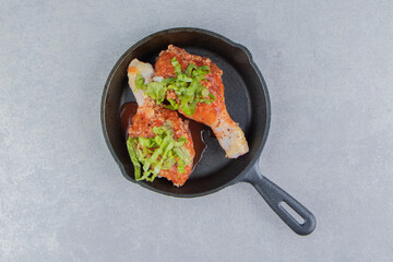 Chicken leg and green on the boiler, on the white background