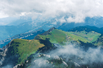 Landscape with clouds on the green mountains.