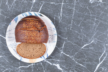 Rye bread without yeast on the plate , on the marble background