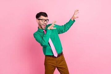 Photo of impressed funky man dressed green shirt eyewear dancing showing arms claws isolated pink color background