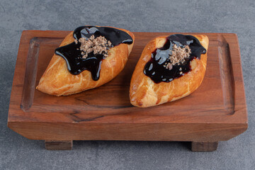 Delicious sweet triangle pastry on a wooden board