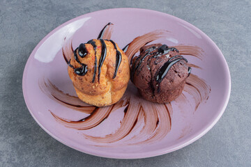 Two delicious sweet cupcakes on a plate