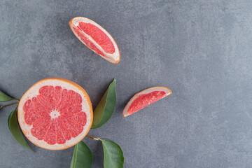 Grapefruits and leaves on a gray background