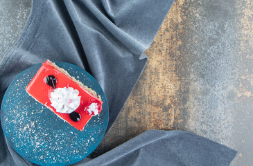 Slice of fruit cake on blue board