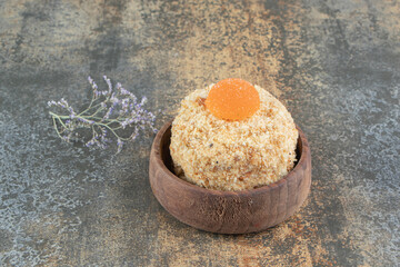 A wooden bowl with delicious sweet cake